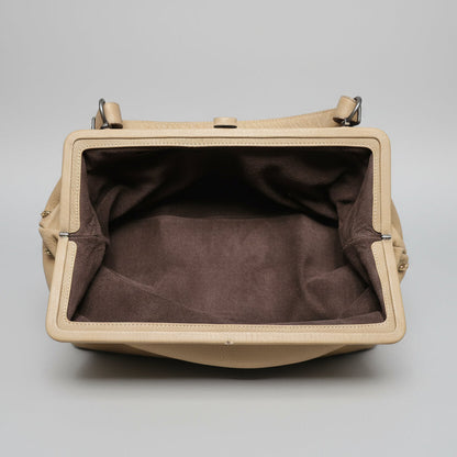Beige handbag with brown interior on a gray background