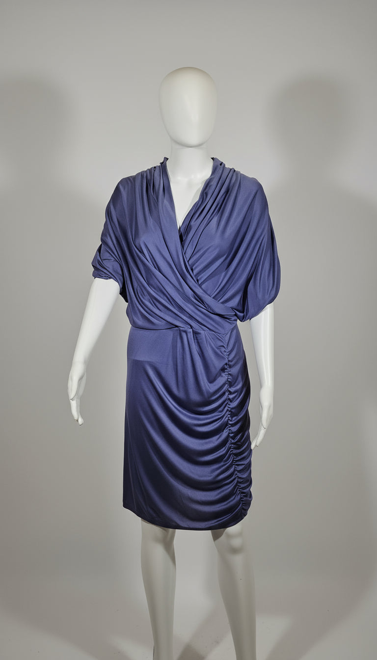 Blue grey dress on a mannequin against a gray background
