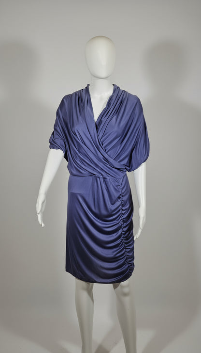Blue grey dress on a mannequin against a gray background