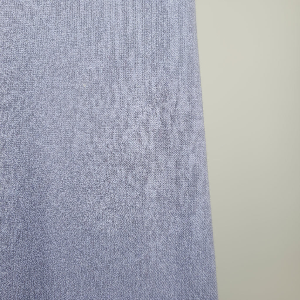 Close-up of a textured blue fabric with a neutral background