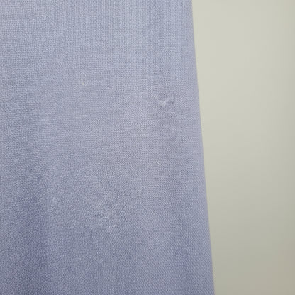 Close-up of a textured blue fabric with a neutral background
