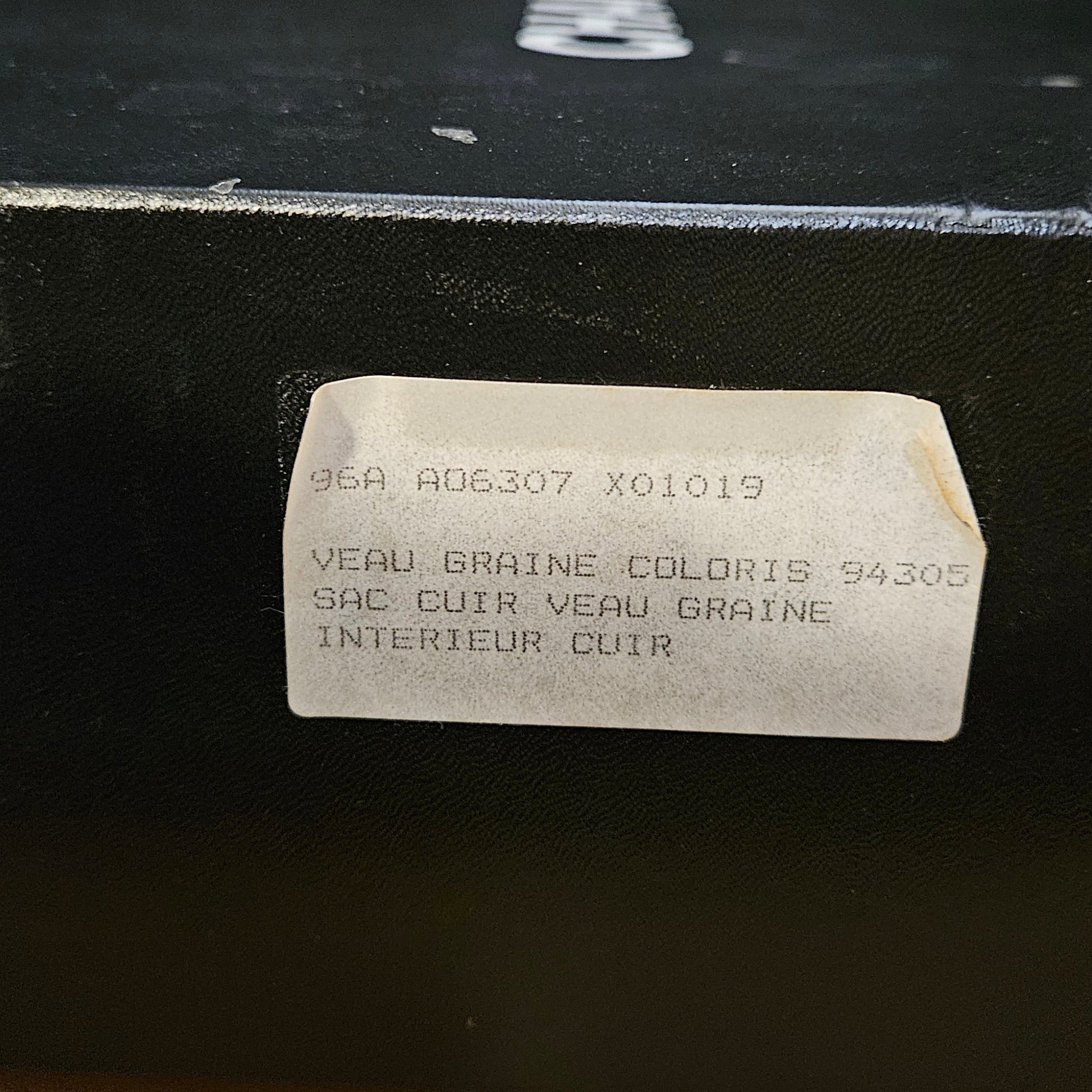 White rectangular label with text on a black surface