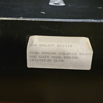 White rectangular label with text on a black surface