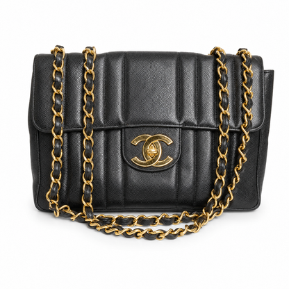 Black quilted handbag with gold chain strap and logo on a white background