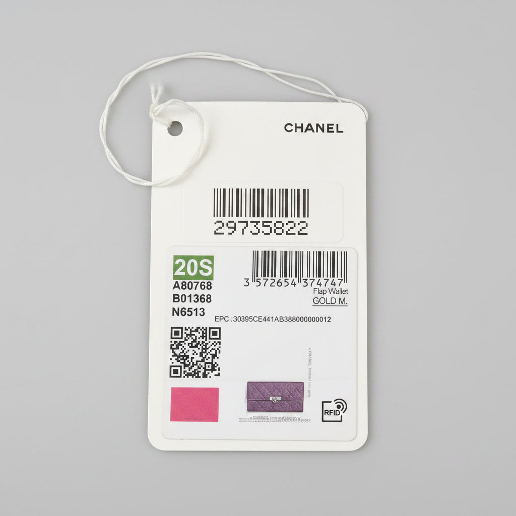Product tag with QR code, barcode, and brand name on a dark surface