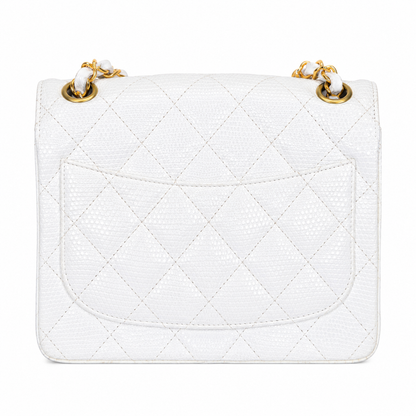 White quilted handbag with gold hardware on a white background