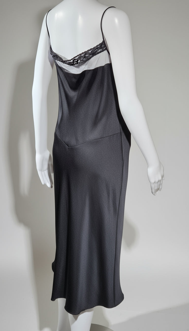 Black slip dress on a mannequin against a plain background