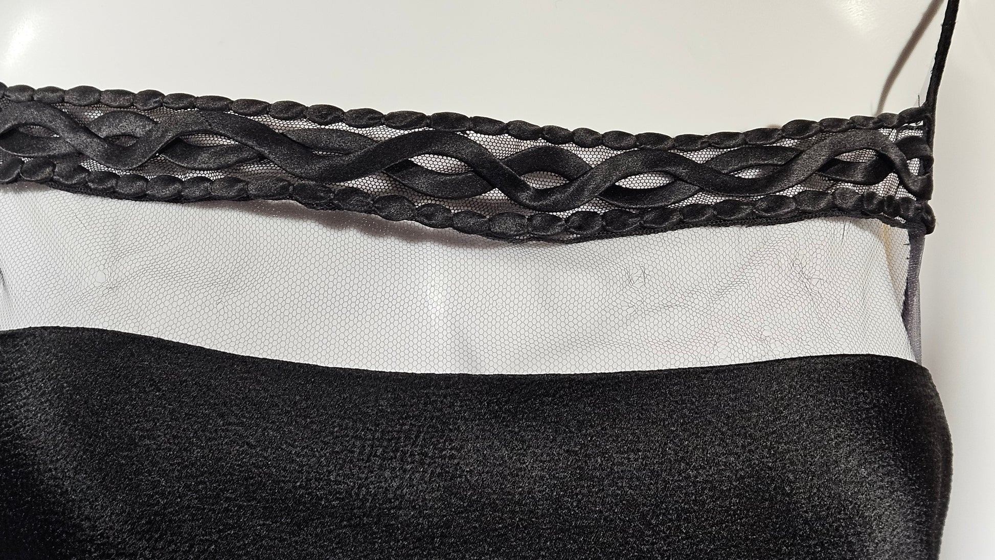 Close-up of a black dress on a white background