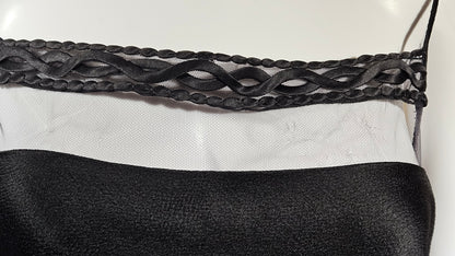 Close-up of a black dress on a white background