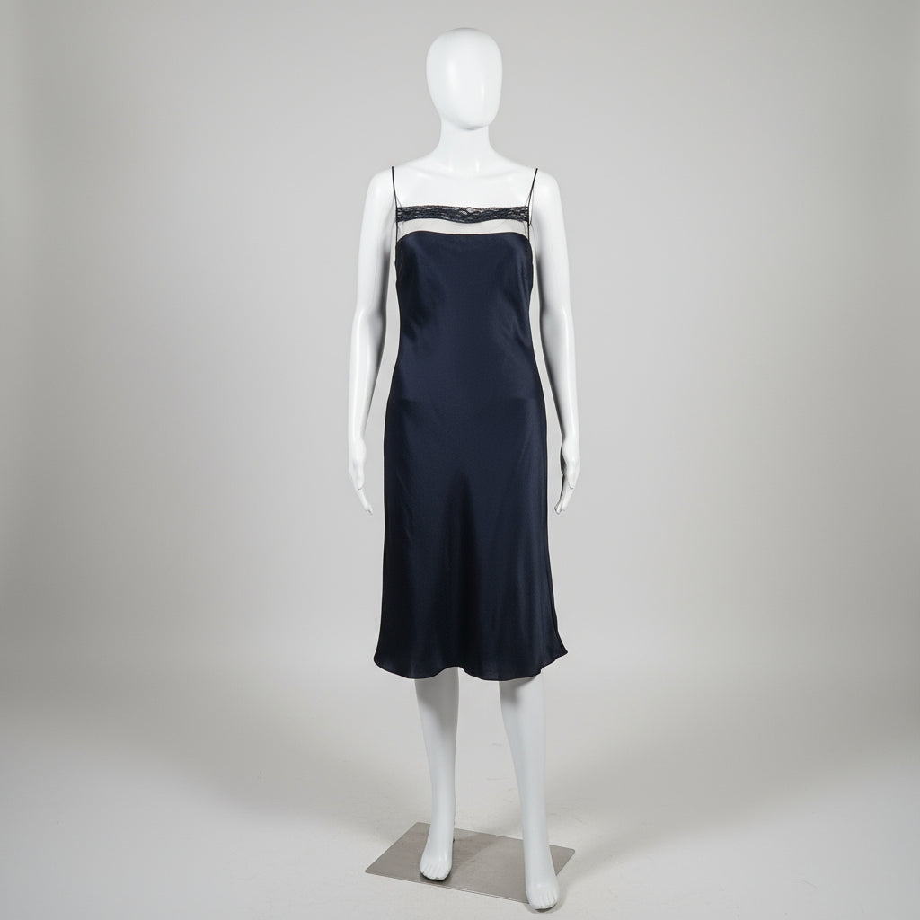 black slip dress on a white mannequin against a plain background