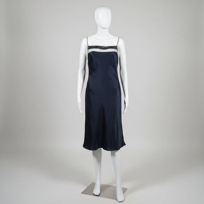 black slip dress on a white mannequin against a plain background