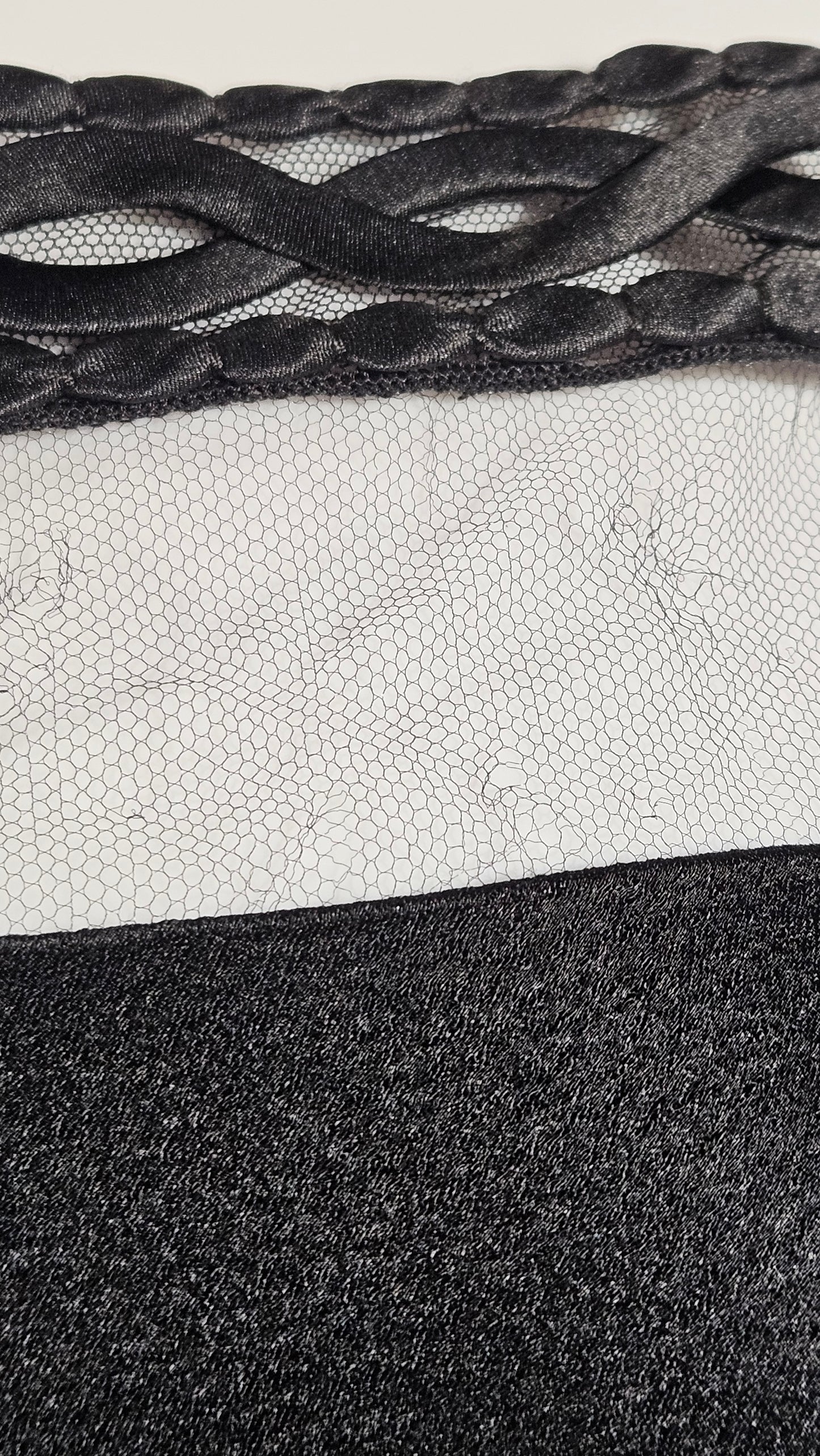 Close-up of textured black, white, and gray fabric samples.