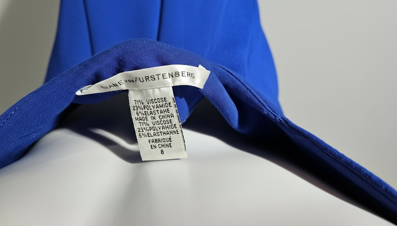 Blue garment on a hanger with a label on a gray background