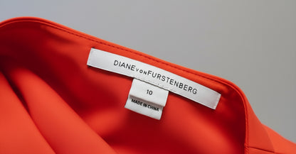 DVF label on a orange garment with a neutral background
