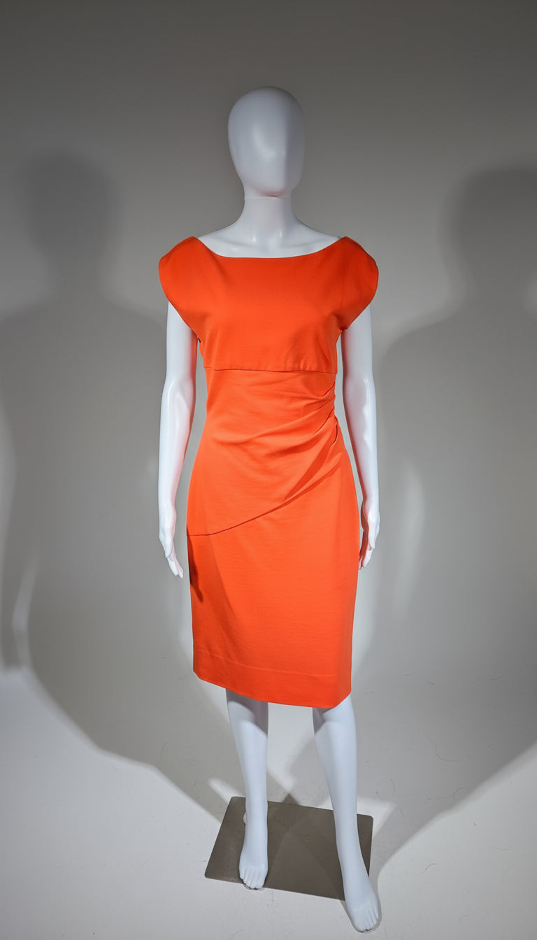 Orange dress on a mannequin against a neutral background