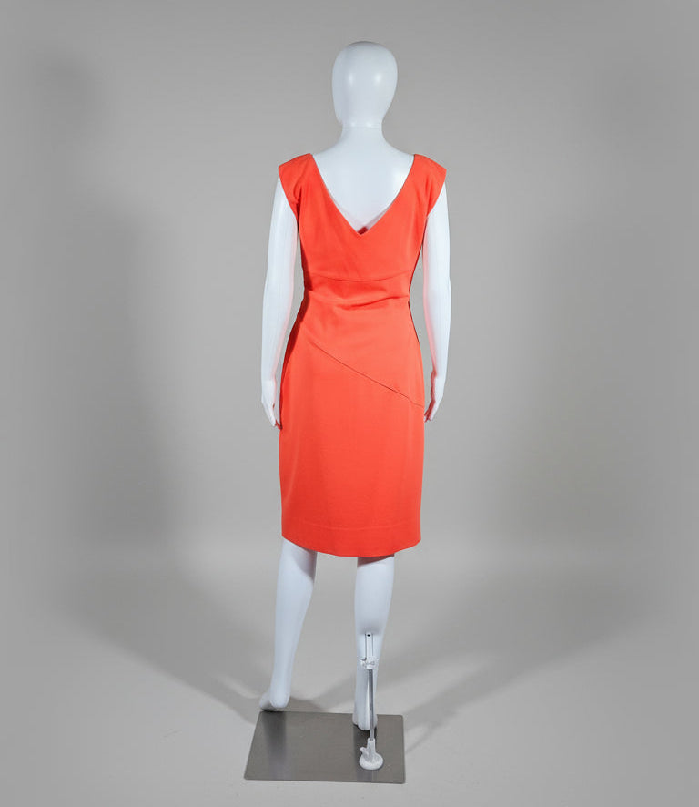 Orange dress on a mannequin against a gray background