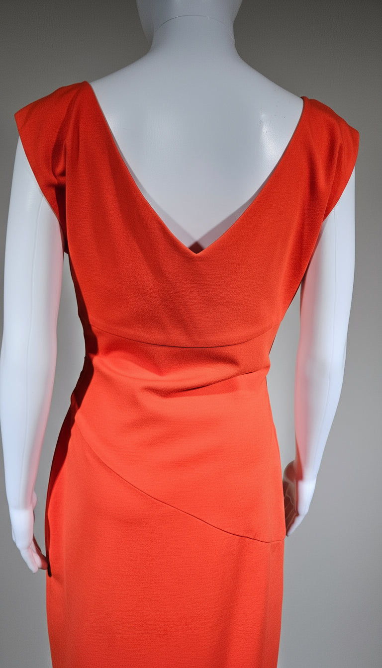 Orange evening gown on a mannequin against a gray background