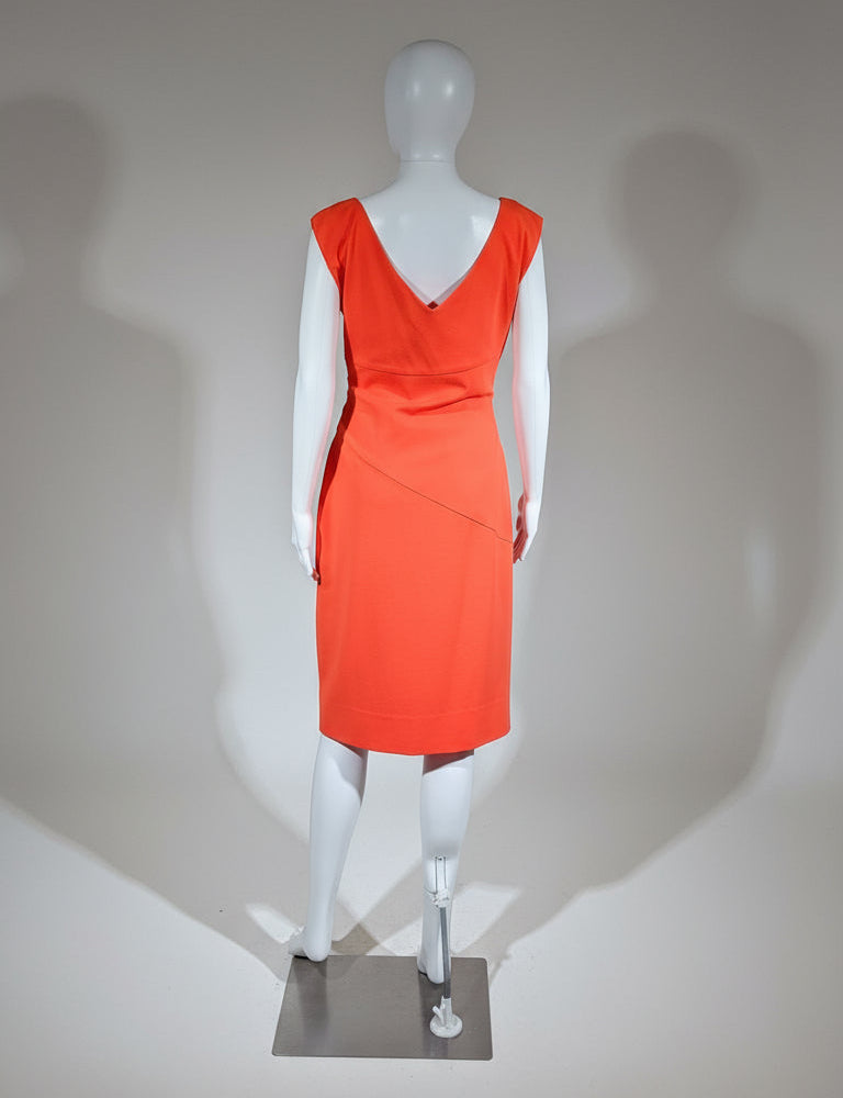 Orange dress on a mannequin against a neutral background