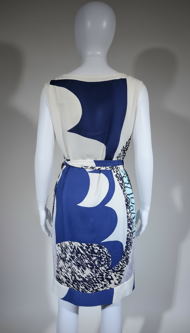 Mannequin wearing a blue and white patterned dress with a textured belt against a gray background