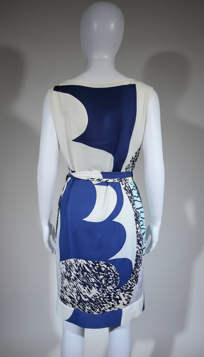 Mannequin wearing a blue and white patterned dress with a textured belt against a gray background