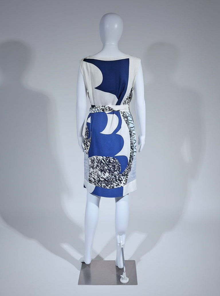 Mannequin wearing a dress with abstract blue and white design on a gray background