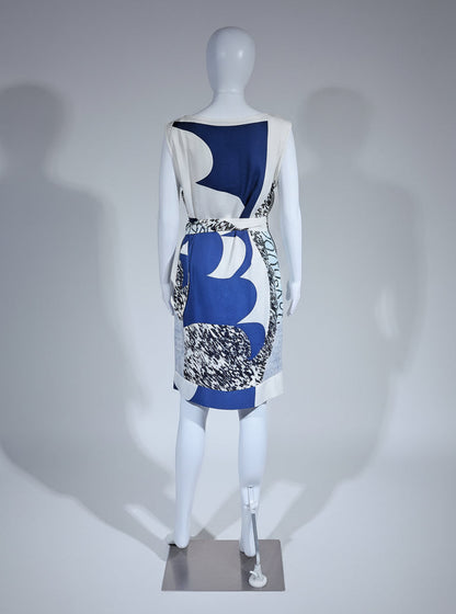 Mannequin wearing a dress with abstract blue and white design on a gray background