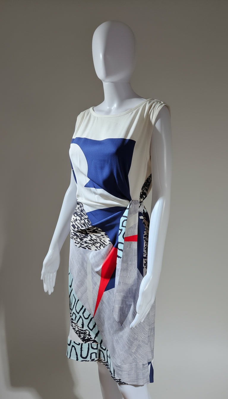 Mannequin wearing a dress with a colorful abstract design on a plain background