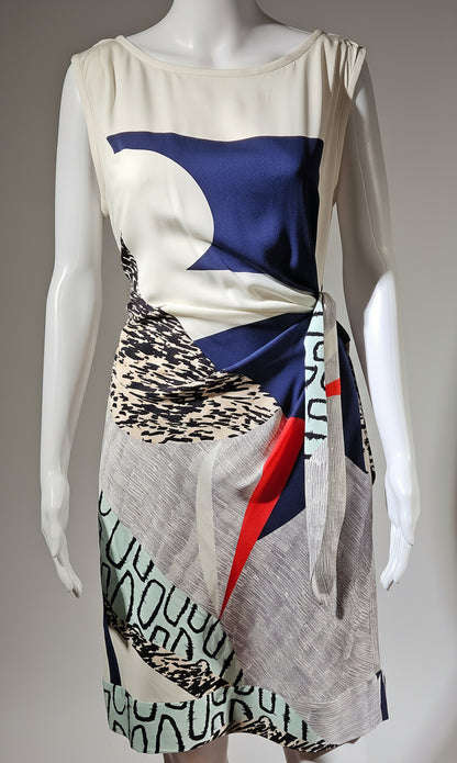 Mannequin wearing a dress with abstract patterns on a plain background