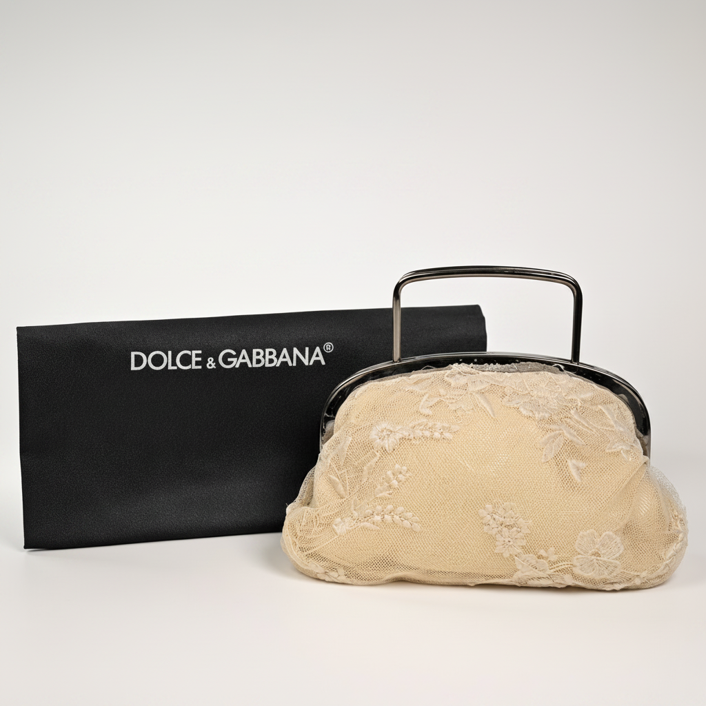 Beige lace handbag with metal handle and Dolce & Gabbana logo in the background