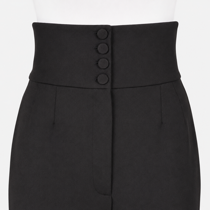Black pants with four button detail closure on a white background