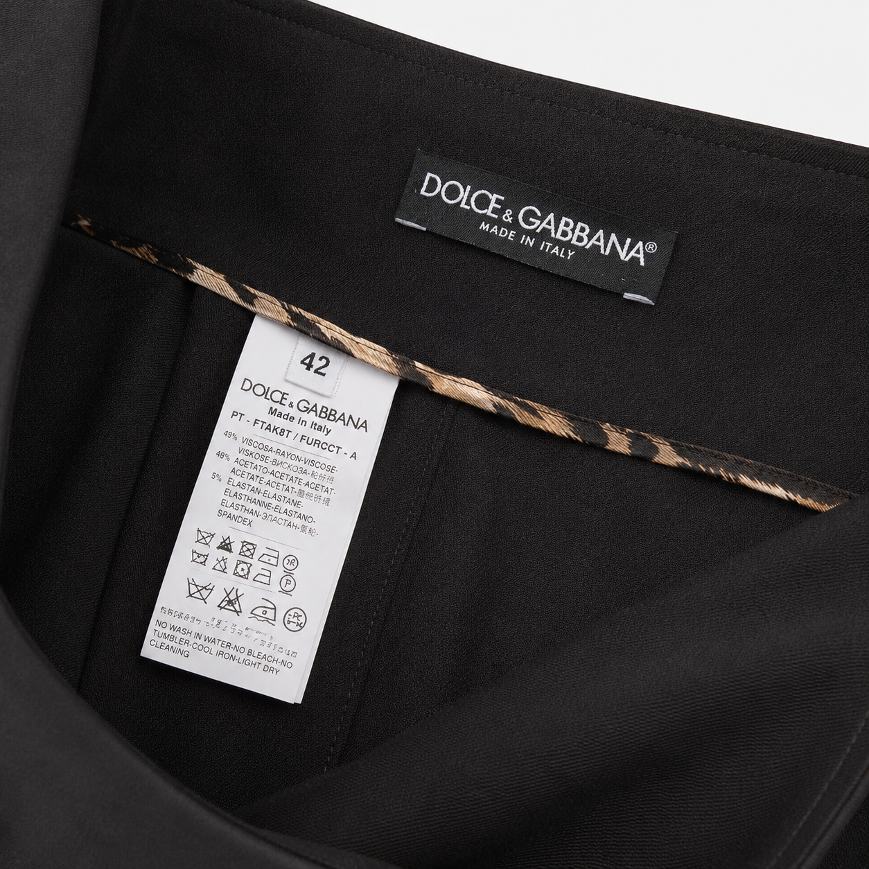 Dolce & Gabbana label on a black garment with a leopard print trim.