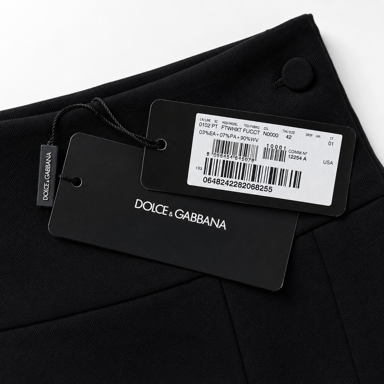 Dolce & Gabbana label on a black garment with a white background