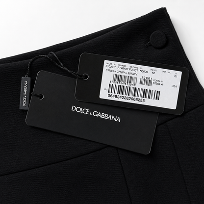 Dolce & Gabbana label on a black garment with a white background