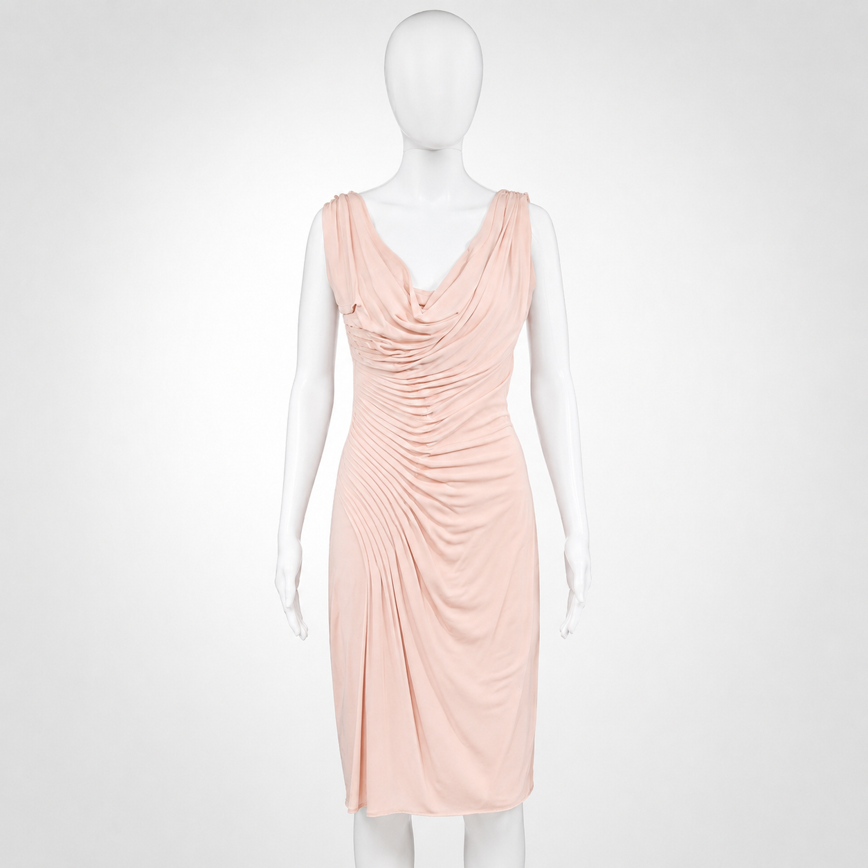 Mannequin wearing a light pink dress on a white background
