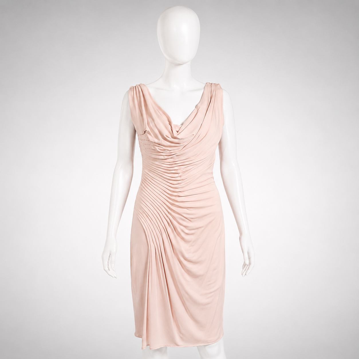 Mannequin wearing a light pink dress on a white background