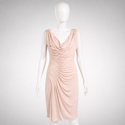 Mannequin wearing a light pink dress on a white background