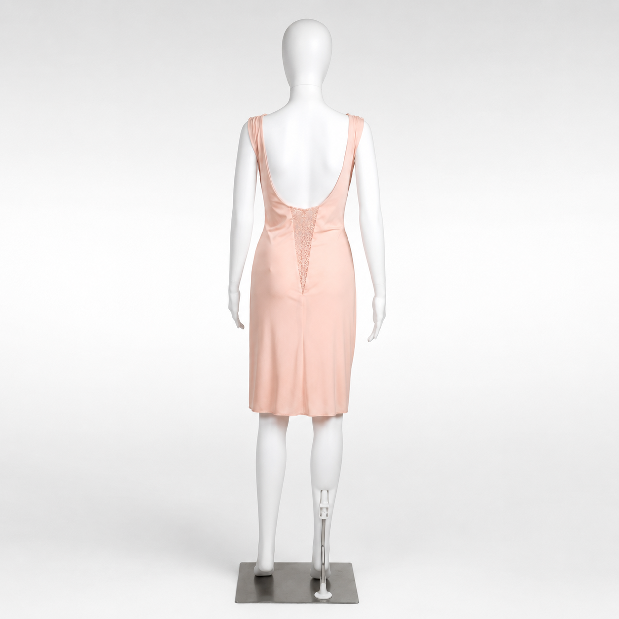 Mannequin wearing a light pink dress on a white background