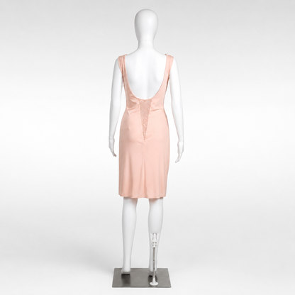 Mannequin wearing a light pink dress on a white background