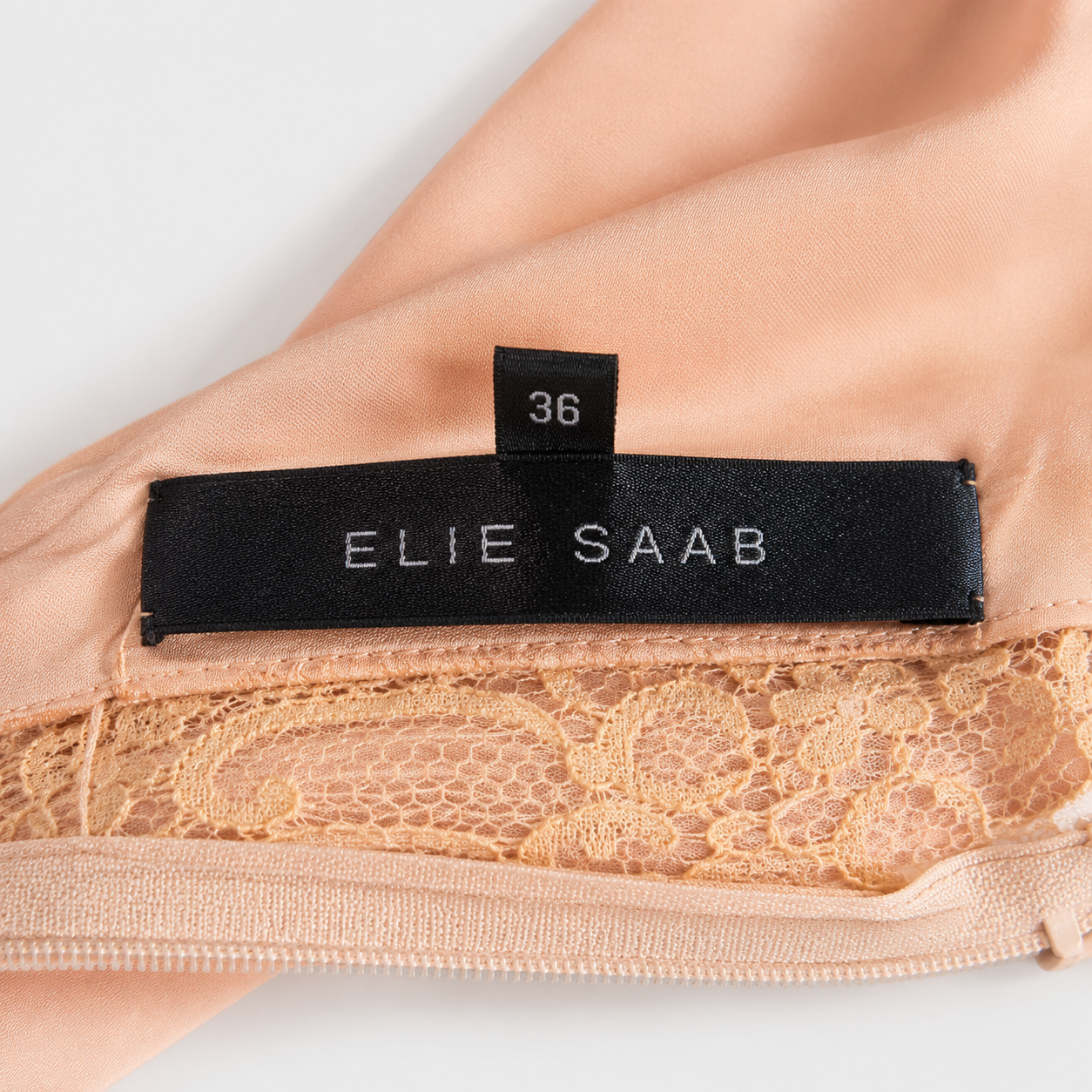Nude lace garment with Elie Saab label on a white background