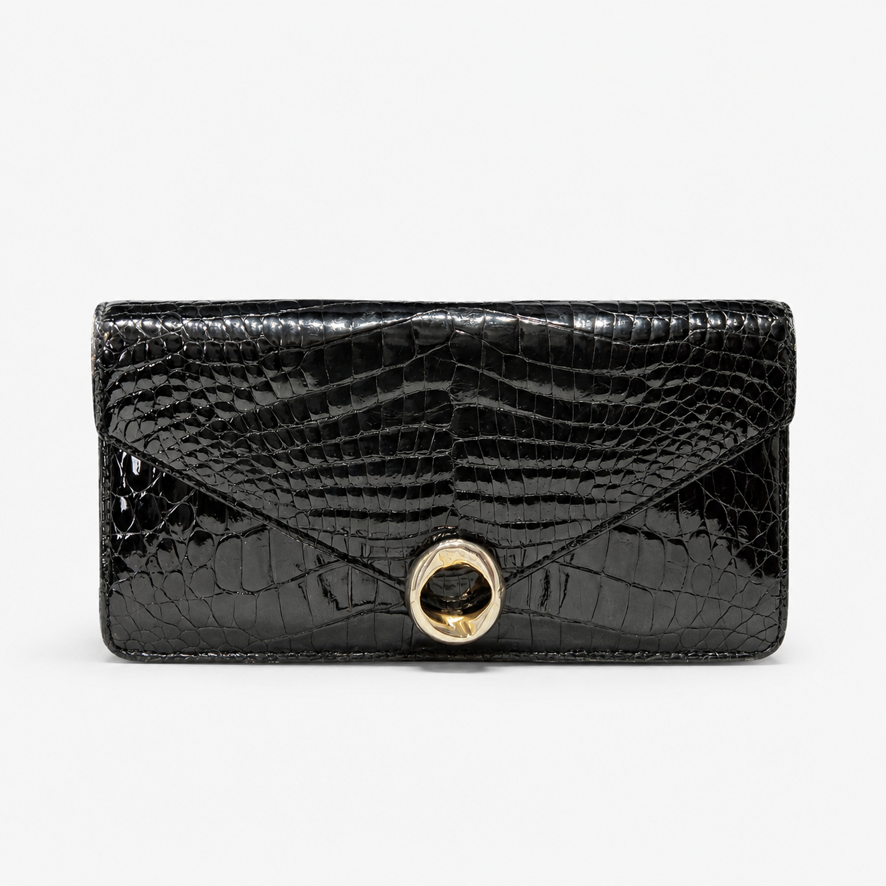 Black crocodile-patterned clutch handbag with a gold clasp on a white background