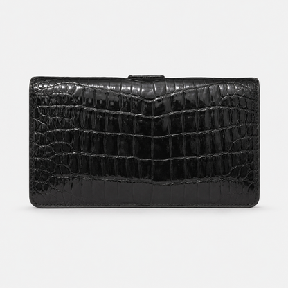 Black crocodile-patterned handbag on a white background