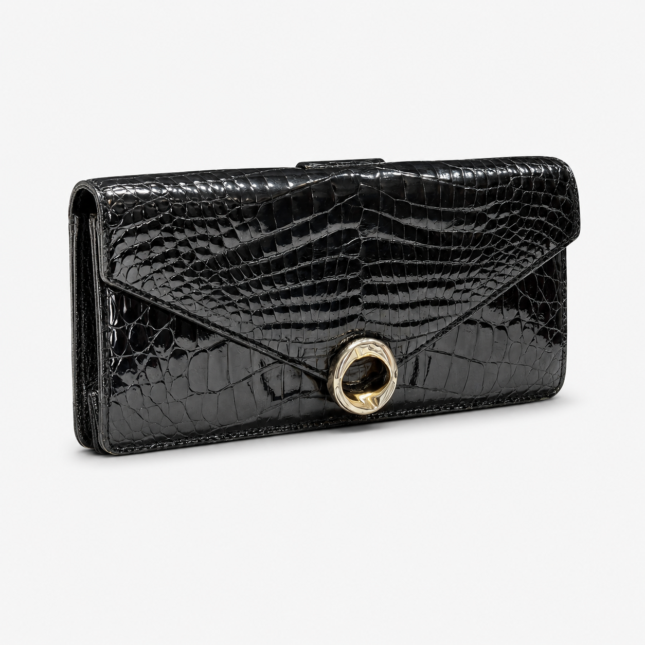 Black crocodile-patterned clutch handbag with a gold clasp on a white background