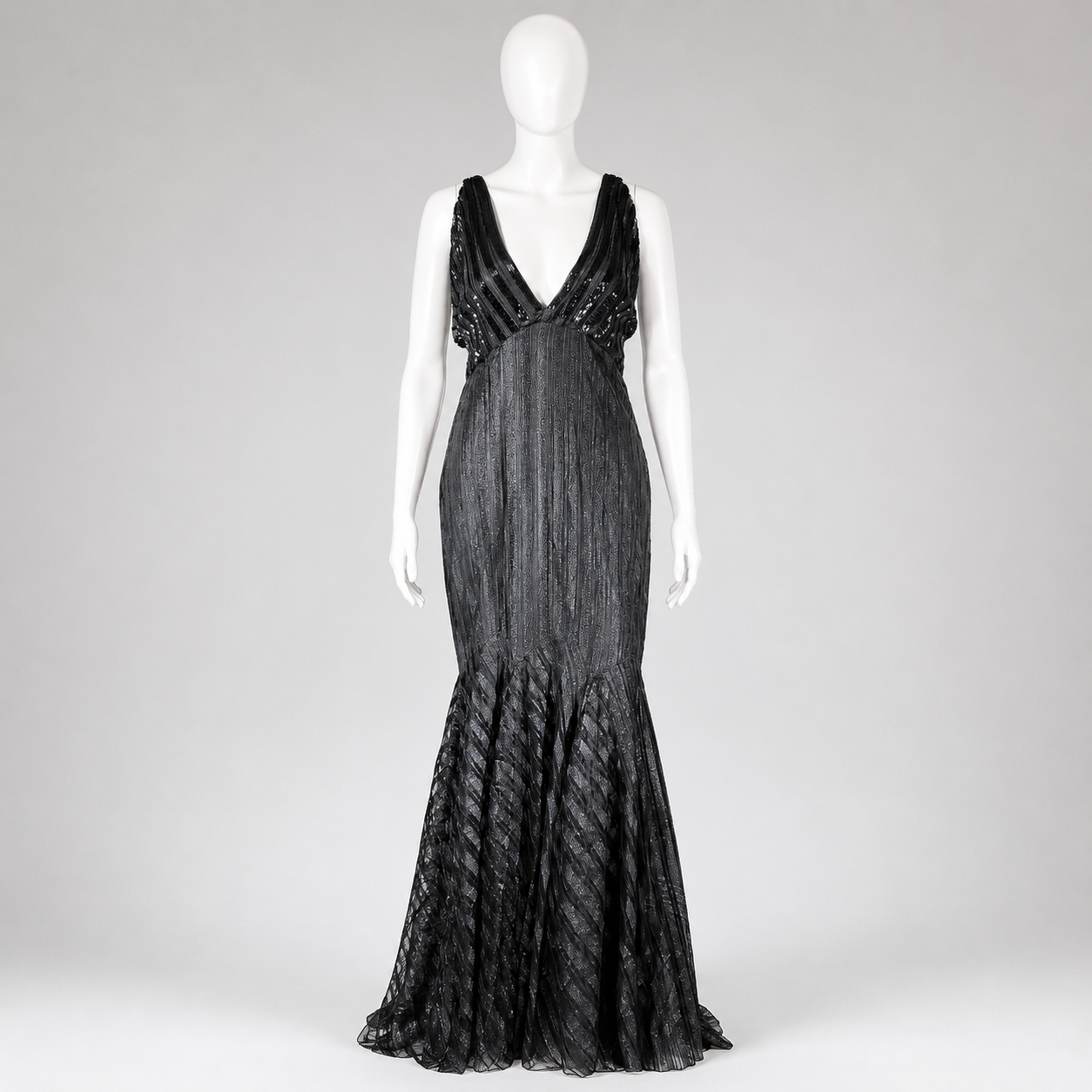 Black evening gown on a mannequin against a white background