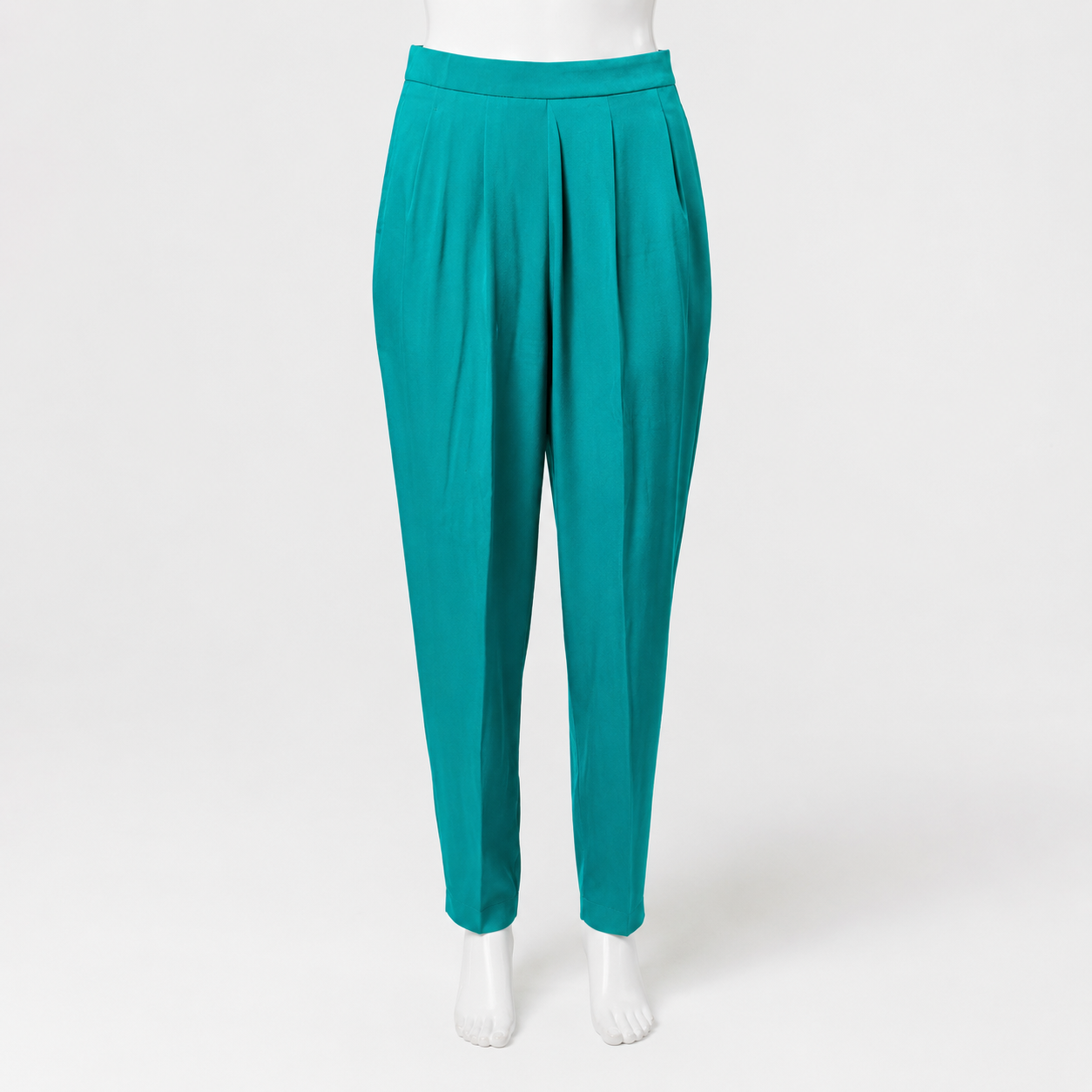 Teal pants on a mannequin against a white background