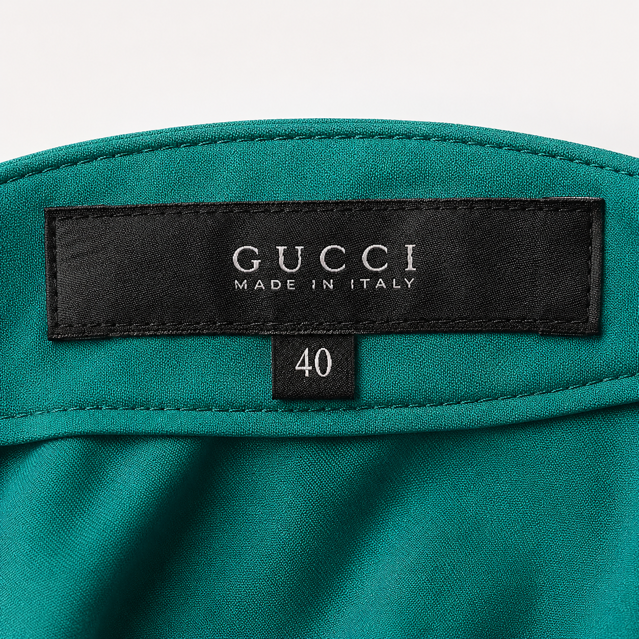Teal fabric with Gucci label and 'Made in Italy' text