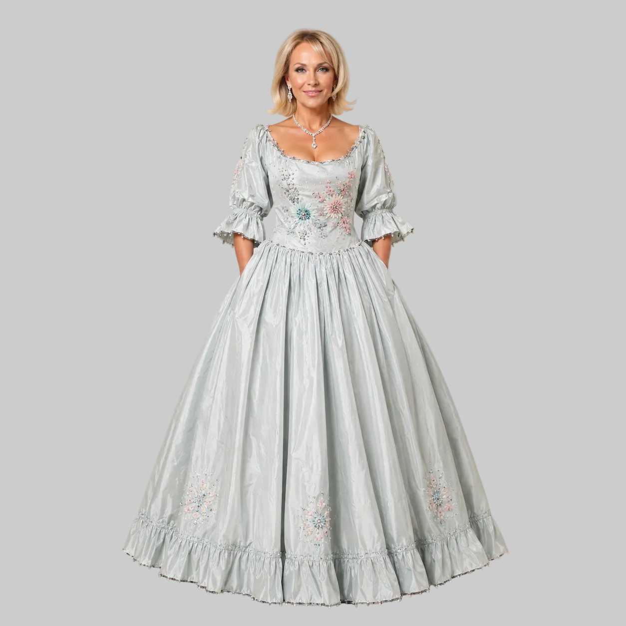 Woman wearing a light blue embroidered dress against a plain background