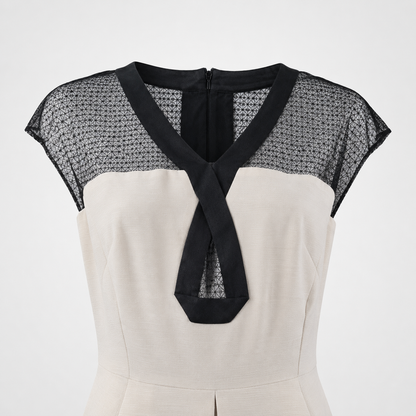 White dress with black mesh sleeves on a white background
