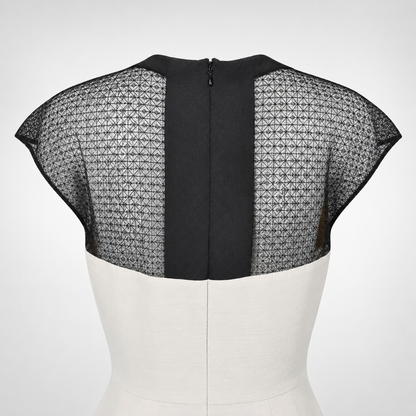 Black and white dress on a mannequin with geometric patterned sleeves against a white background
