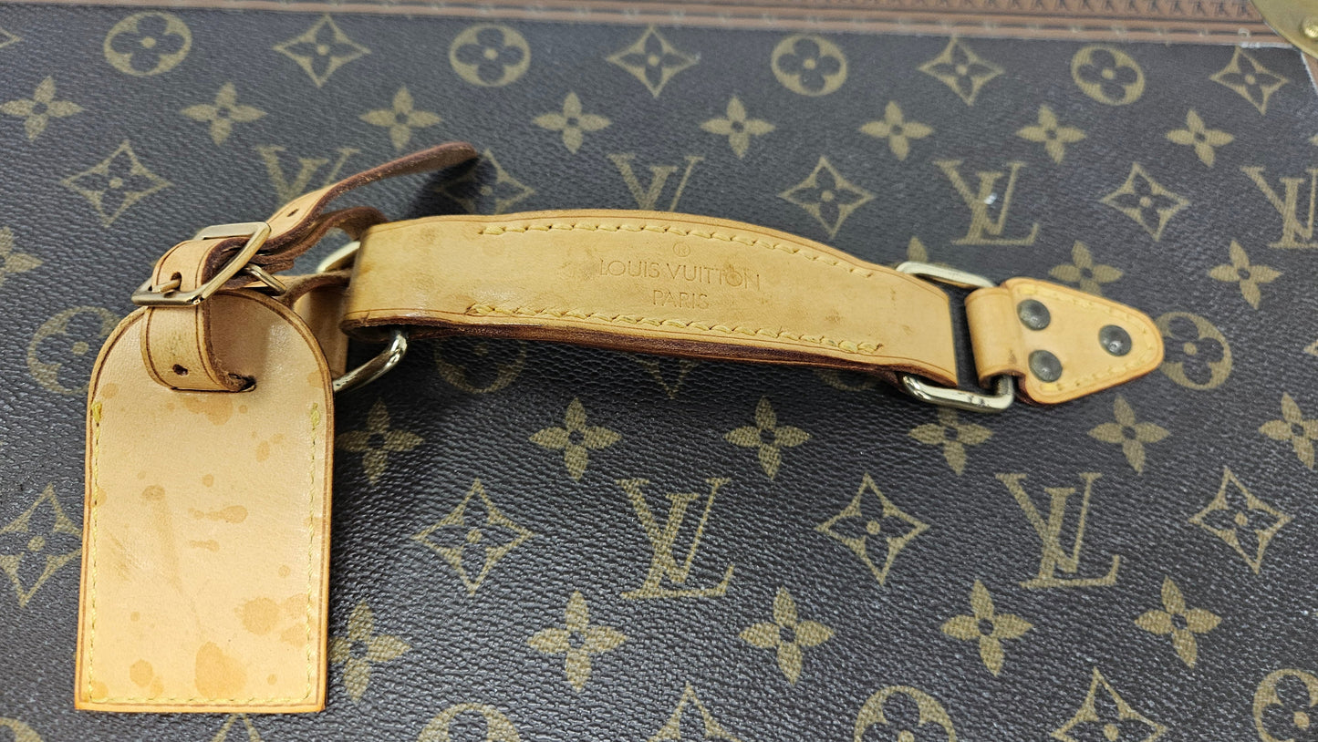 Close-up of a Louis Vuitton monogram handbag with a visible brand logo.