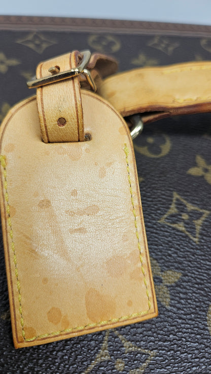 Close-up of a Louis Vuitton luggage tag with light water stain.